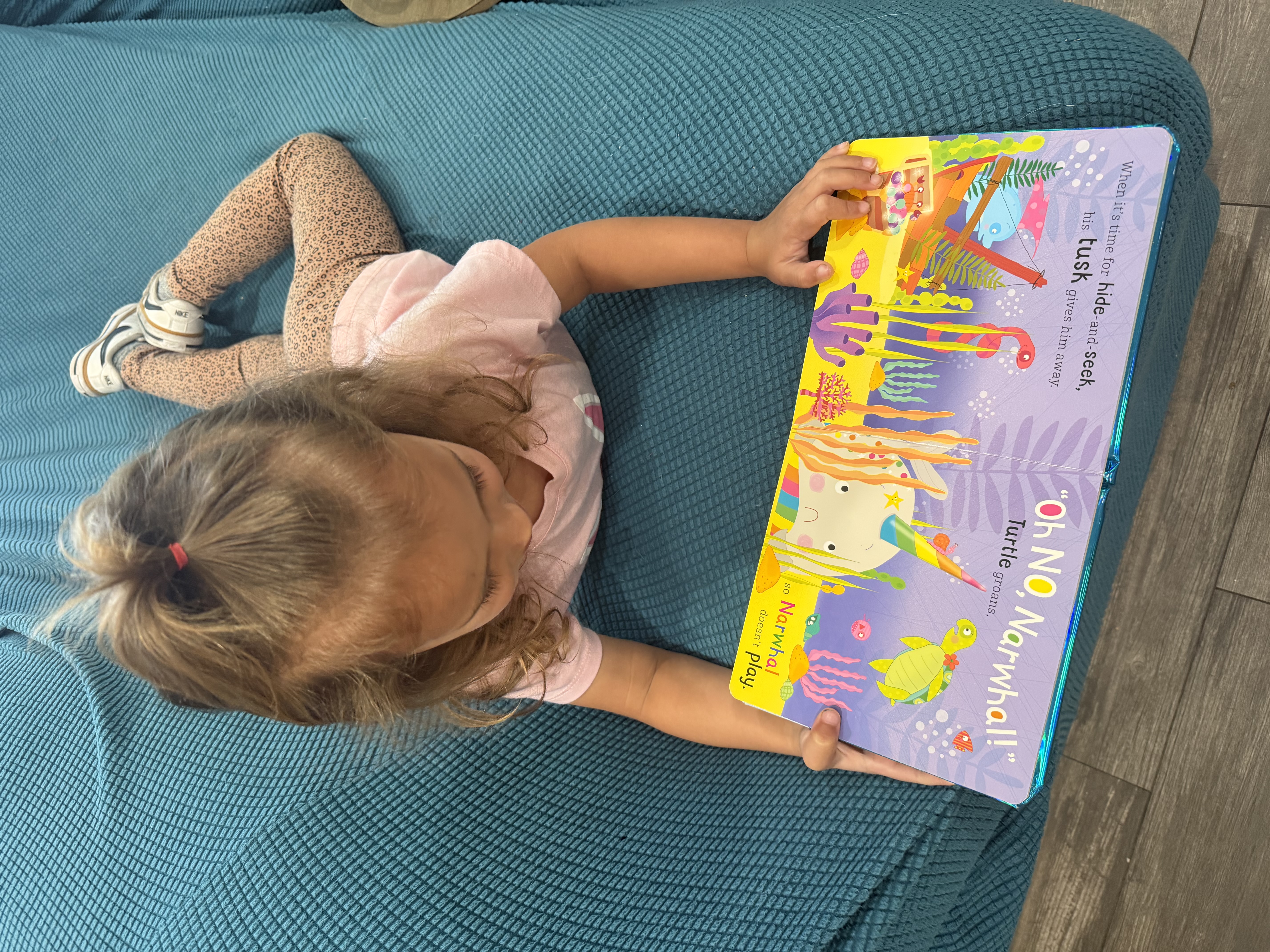 Girl reading a book on a couch