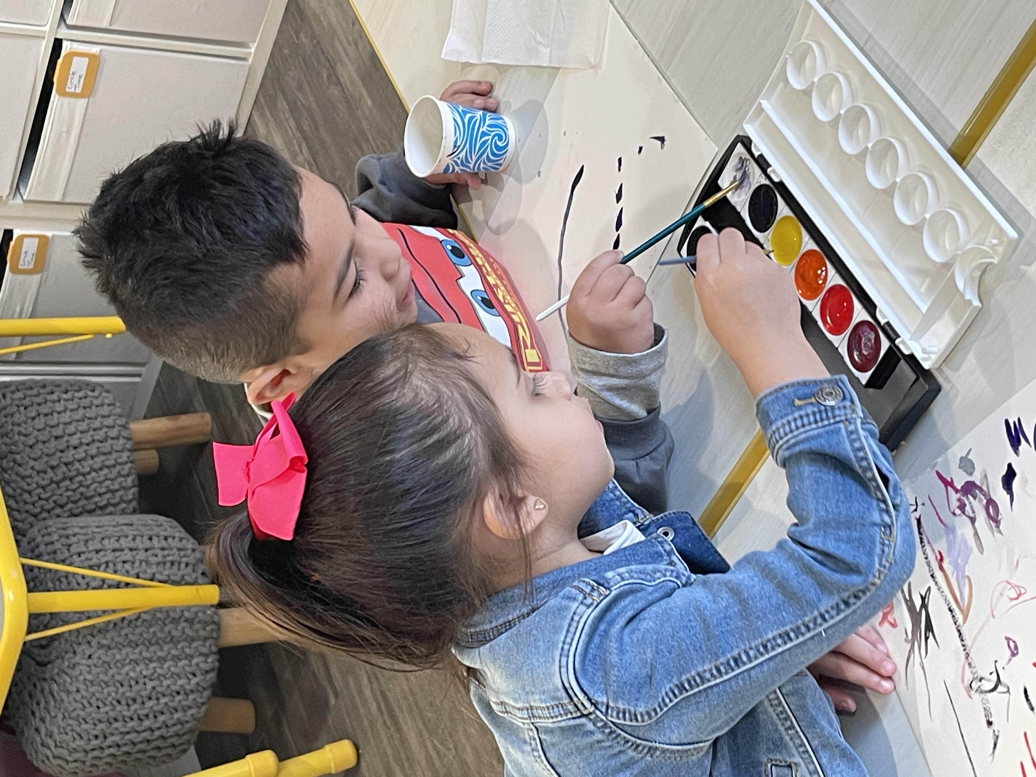 Caregiver reading with children outdoors